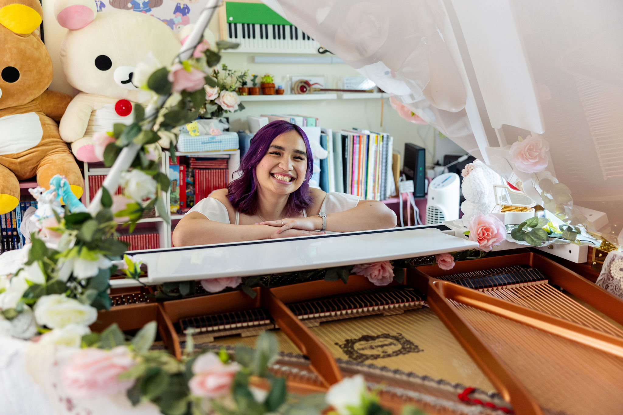 Smiling behind the open piano lid